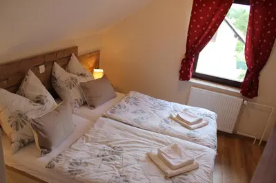 a bedroom with a bed with two towels on it at Guesthouse Veranda in Mojstrana