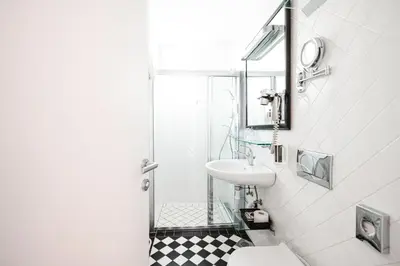a bathroom with a sink and a toilet and a shower at Penzion Vila Prešeren in Bled