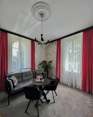 a living room with a couch and a table at Penzion Vila Prešeren in Bled