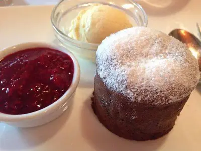 a chocolate cake and a bowl of jam on a table at Penzion Plac ob železnici in Loče pri Poljčanah