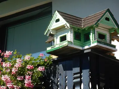 a bird house on the side of a house at Apartments & Rooms Preseren in Bled