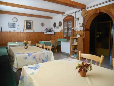 a living room with two tables and a kitchen at Apartments & Rooms Preseren in Bled
