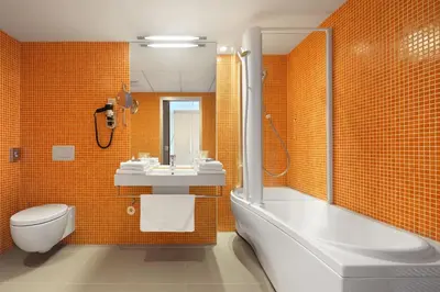 a bathroom with a tub and a sink and a toilet at Hotel Thermana Park Laško**** Superior in Laško