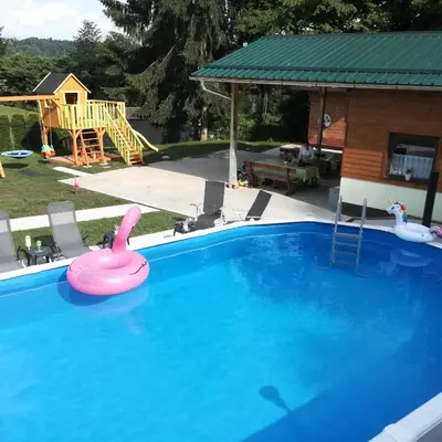 a swimming pool with a pink swan in a yard at Apartment Jelovca - in the attic in Radovljica