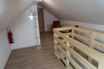 a bedroom with a bunk bed and a floor lamp at Apartment Jelovca - in the attic in Radovljica