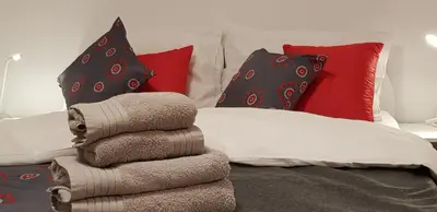 a pile of towels sitting on a bed with pillows at Apartments Vijolica on the ski slope with free parking in Kranjska Gora