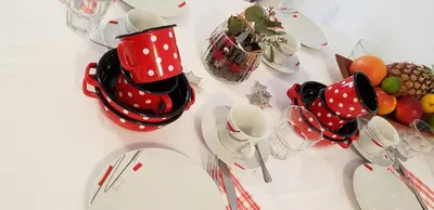 a table with red and white polka dot cups and plates at Apartments Vijolica on the ski slope with free parking in Kranjska Gora