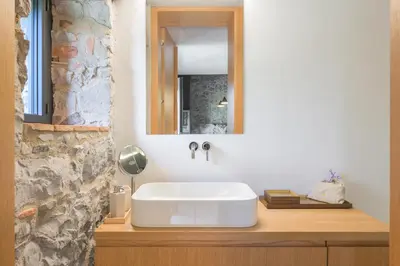 a bathroom with a sink and a mirror on a counter at Kambra in Dutovlje