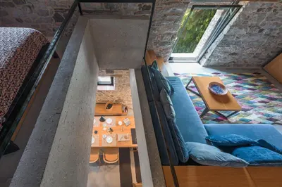 a room with a couch and a table in a room at Kambra in Dutovlje