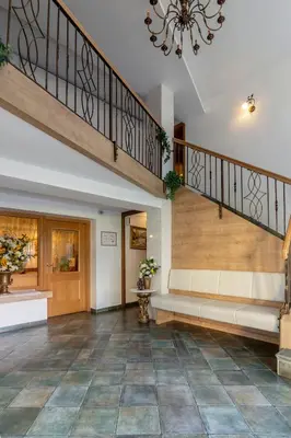 a lobby with a staircase and a lobby at Jagodic Garni Hotel in Cerklje na Gorenjskem