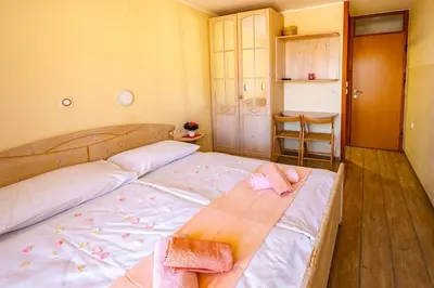 a bedroom with a bed with two towels on it at Slovenian Traditional Guest House in Begunje na Gorenjskem