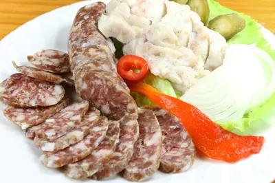 a plate of food with meat and vegetables on it at Slovenian Traditional Guest House in Begunje na Gorenjskem