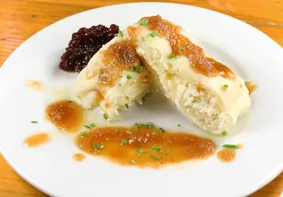 a white plate with two pieces of food on it at Slovenian Traditional Guest House in Begunje na Gorenjskem