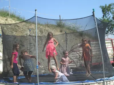 a group of children playing on a trampoline at Slovenian Traditional Guest House in Begunje na Gorenjskem