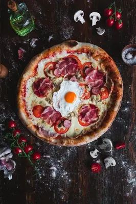 a pizza with an egg on top of a table at Gostilna Logar in Hotemaže