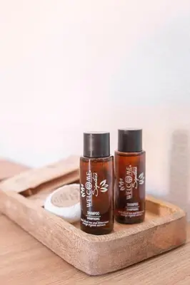 two bottles of essential oils on a wooden tray at Gostilna Logar in Hotemaže