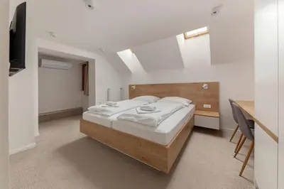 a bedroom with a bed and a desk at Gostilna Logar in Hotemaže