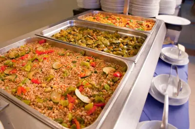two trays of food on a buffet table at Terme Topolsica - Hotel Vesna in Topolšica