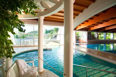 a swimming pool in a building with a swimming pool at Terme Topolsica - Hotel Vesna in Topolšica