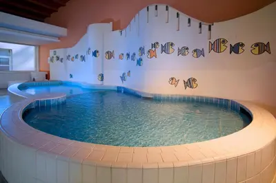 a large swimming pool in a building at Terme Topolsica - Hotel Vesna in Topolšica