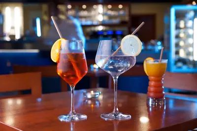 three cocktails sitting on a table in a bar at Terme Topolsica - Hotel Vesna in Topolšica