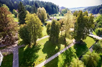 an overhead view of a park with trees and a cross at Terme Topolsica - Hotel Vesna in Topolšica