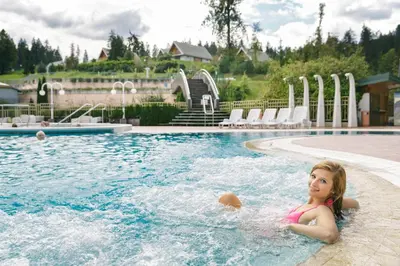 a young girl swimming in a swimming pool at Terme Topolsica - Hotel Vesna in Topolšica
