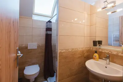 a bathroom with a sink and a toilet and a window at Apartments Dominika in Bohinjska Bela