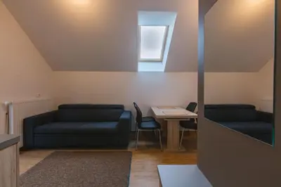 a living room with two blue couches and a table at Apartments Dominika in Bohinjska Bela