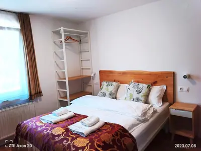 a bedroom with a bed with towels on it at Pension MOYCHI in Bled