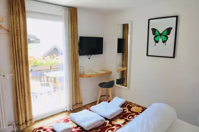 a bedroom with a bed and a butterfly on the wall at Pension MOYCHI in Bled