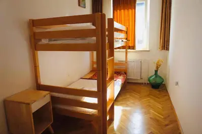 a room with two bunk beds in a room at Pension MOYCHI in Bled