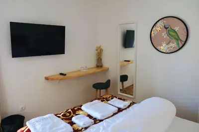 a bedroom with a bed with towels on it at Pension MOYCHI in Bled