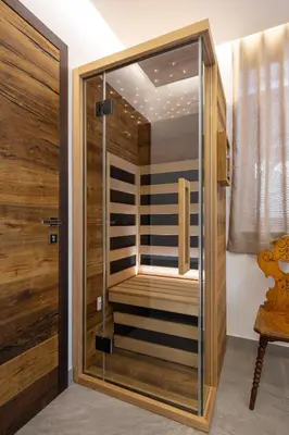 a walk in shower with a glass door at Kotnik Superior Boutique Hotel in Kranjska Gora