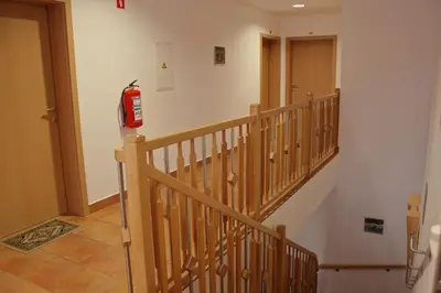 a wooden staircase with a fire hydrant on the wall at Garni Hotel Villa Tamara in Moravske Toplice