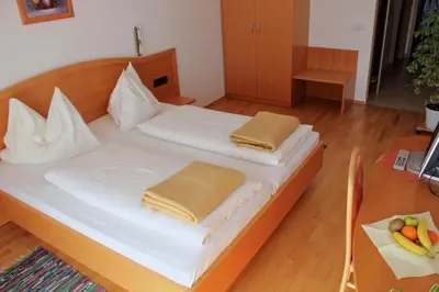 a bedroom with a bed with two pillows on it at Garni Hotel Villa Tamara in Moravske Toplice