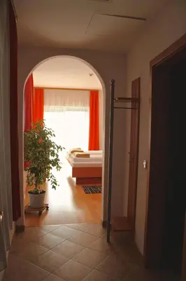 a hallway with a room with a bed and a window at Garni Hotel Villa Tamara in Moravske Toplice