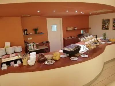 a kitchen with a counter with food on it at Ambient Hotel in Domžale