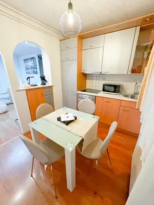 a kitchen with a white table and chairs at Apartments Šentvid in Ljubljana