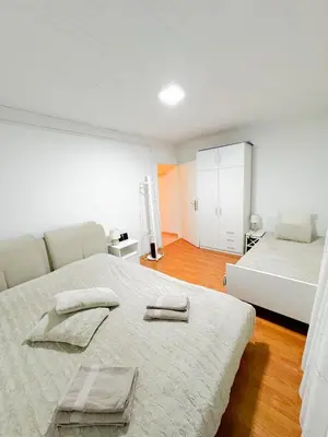a bedroom with two beds with towels on the bed at Apartments Šentvid in Ljubljana