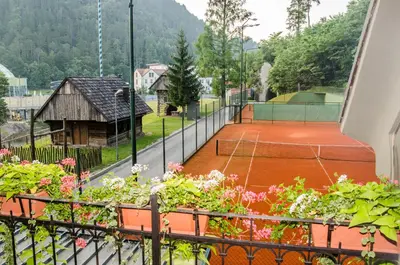 a tennis court with flowers on a balcony at Penzion Park in Laško