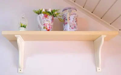 a shelf with two vases and a bird cage at Penzion Park in Laško