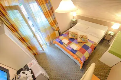 a small bedroom with a bed and a window at Penzion Park in Laško