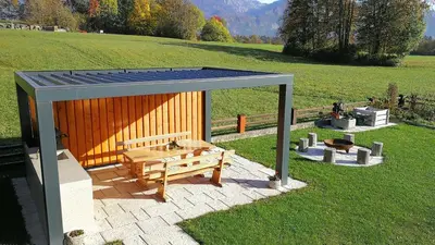 a gazebo with a picnic table and a bench at Apartments Kristan in Bled