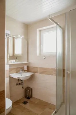 a bathroom with a sink and a shower at Apartments Kristan in Bled