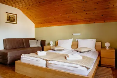 a bedroom with a bed and a couch at Apartments Kristan in Bled