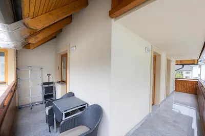 a room with chairs and a table on a balcony at Apartment Arnika Kranjska Gora in Kranjska Gora
