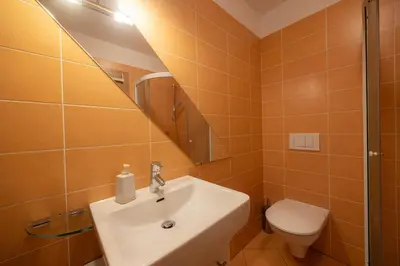 a bathroom with a sink and a toilet at Apartment Arnika Kranjska Gora in Kranjska Gora