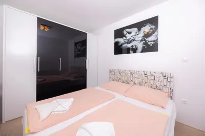 a bedroom with a bed with an orange and white mattress at Apartment Arnika Kranjska Gora in Kranjska Gora