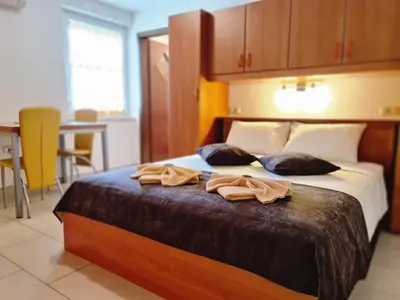 a bedroom with a bed with two towels on it at Restaurant & Apartments Getaway Pri Kobalu in Vipava